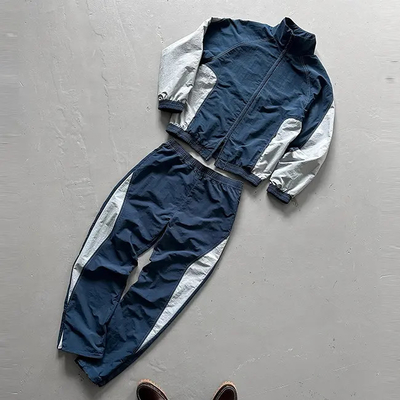Traje de deporte de rompevientos de moda masculina con bolso Traje de trekking de moda masculina de poliéster de nylon de gran tamaño Traje de deporte de rompevientos de moda masculina